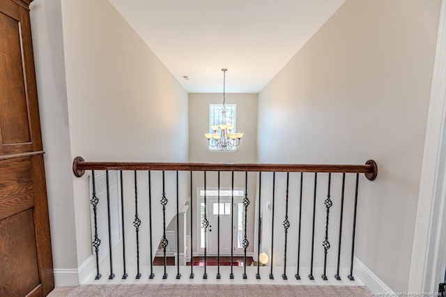 stairs featuring carpet flooring and a chandelier