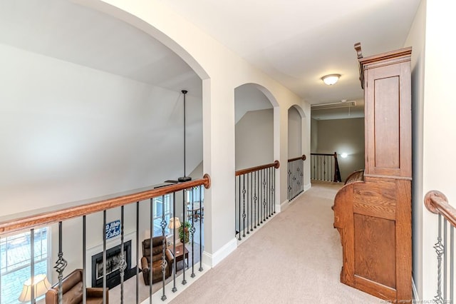 hall with light colored carpet