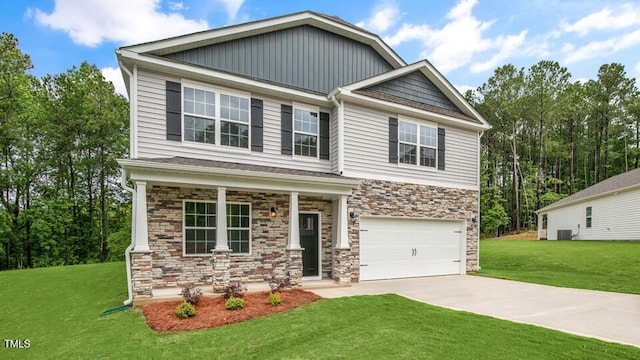 1009 Ocean Ct, Carthage, NC 28327 - craftsman inspired home with stone siding, an attached garage, a porch, and a front lawn