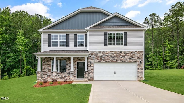 1009 Ocean Ct, Carthage, NC 28327 - craftsman inspired home featuring stone siding, driveway, a front yard, and an attached garage