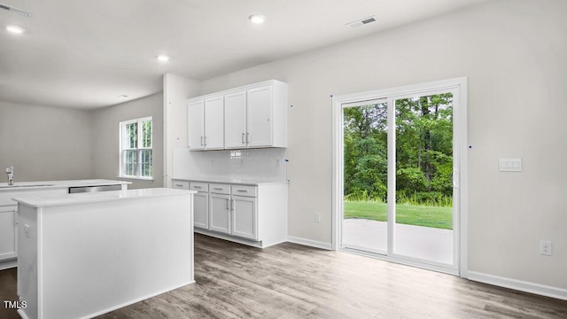 1009 Ocean Ct, Carthage, NC 28327 - kitchen featuring light countertops, wood finished floors, white cabinetry, a kitchen island, and recessed lighting