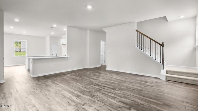1009 Ocean Ct, Carthage, NC 28327 - unfurnished living room with wood finished floors, stairs, and recessed lighting