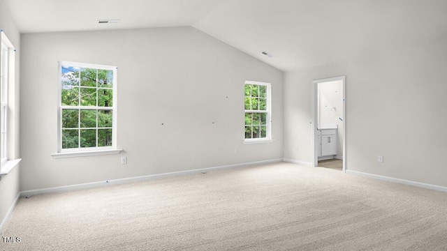 1009 Ocean Ct, Carthage, NC 28327 - unfurnished bedroom featuring light carpet, vaulted ceiling, and connected bathroom