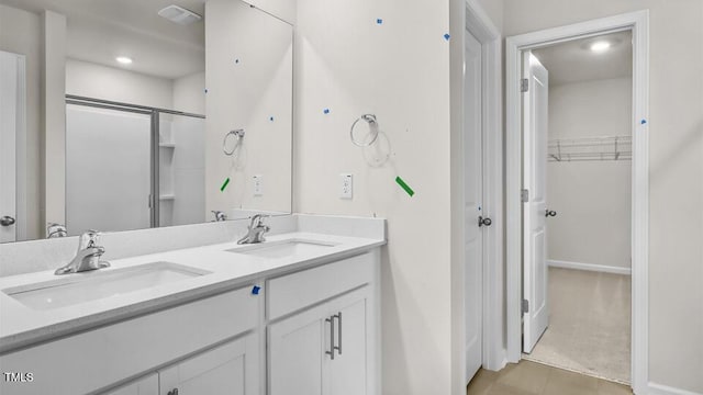 1009 Ocean Ct, Carthage, NC 28327 - full bath featuring a spacious closet, double vanity, tile patterned flooring, and an enclosed shower