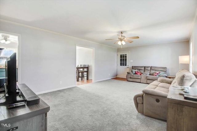 living room with ornamental molding, ceiling fan, and carpet floors