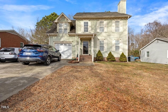 view of front of home with a garage and a front lawn