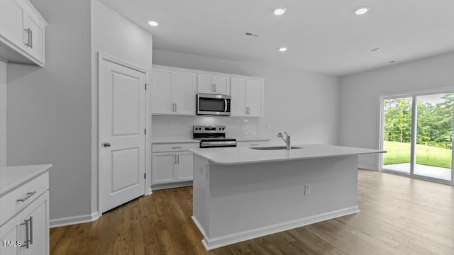 989 Ocean Ct, Carthage, NC 28327 - kitchen with appliances with stainless steel finishes, dark wood-style floors, light countertops, tasteful backsplash, and recessed lighting
