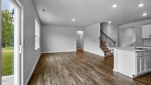 989 Ocean Ct, Carthage, NC 28327 - unfurnished living room with stairway, dark wood-type flooring, healthy amount of natural light, and recessed lighting
