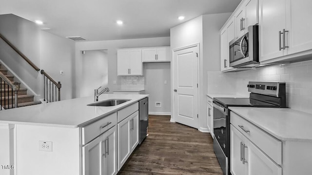 989 Ocean Ct, Carthage, NC 28327 - kitchen featuring stainless steel appliances, backsplash, white cabinets, light countertops, and dark wood-style floors