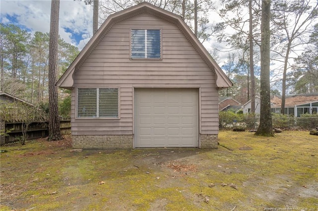 exterior space with an outbuilding, a garage, and a lawn