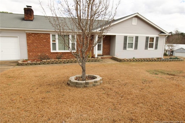 single story home featuring a garage and a front lawn