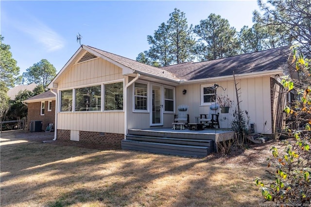back of property with central air condition unit, a shingled roof, a yard, and a deck