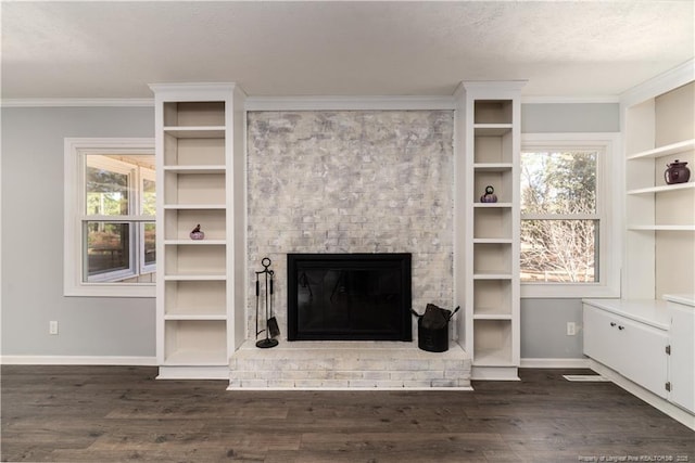 unfurnished living room featuring baseboards, plenty of natural light, a fireplace, and dark wood finished floors