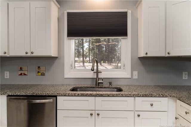 kitchen featuring light stone counters, a sink, dishwasher, and white cabinets