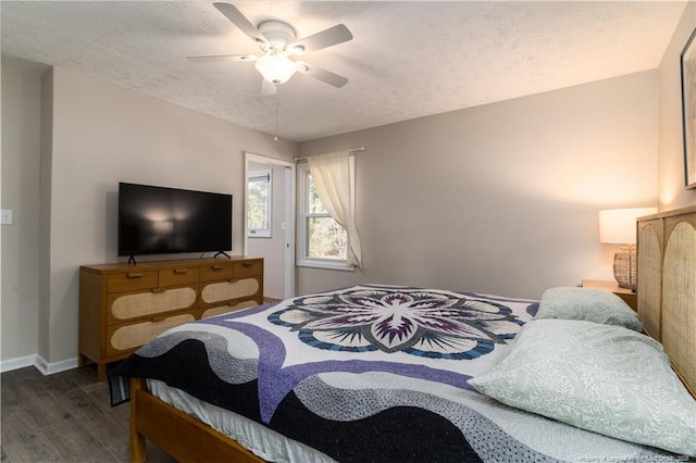 bedroom with baseboards, ceiling fan, a textured ceiling, and wood finished floors