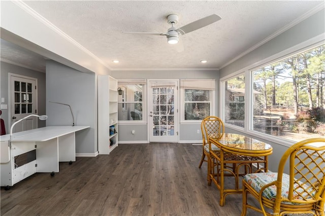 sunroom / solarium featuring crown molding, a textured ceiling, and wood finished floors