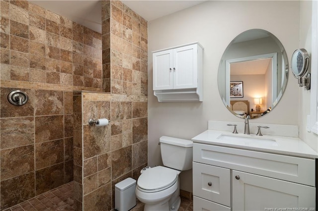 bathroom with vanity, walk in shower, and toilet