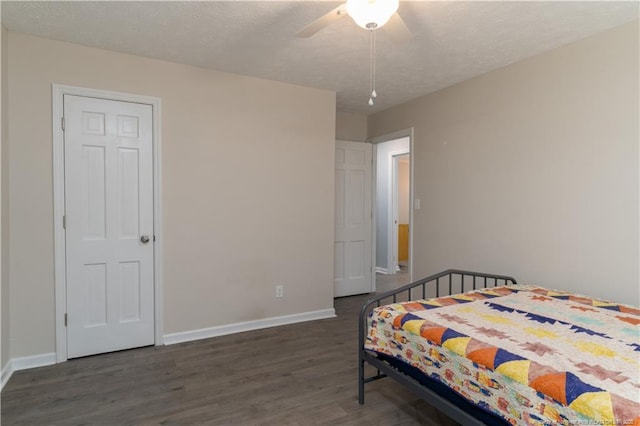bedroom featuring baseboards, a ceiling fan, and wood finished floors