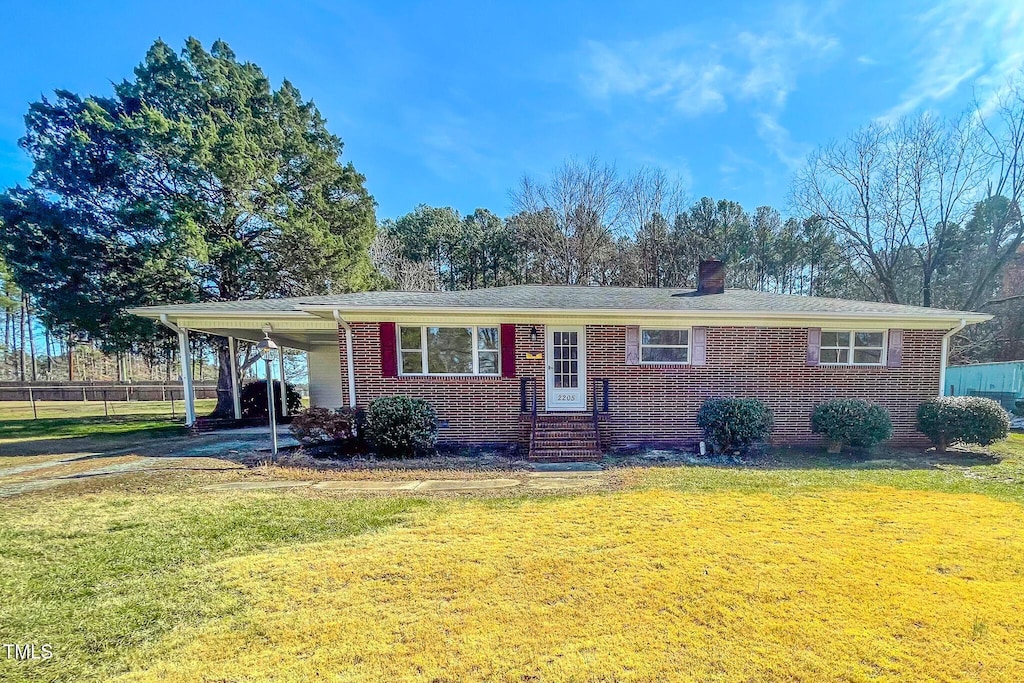 single story home with a carport and a front yard