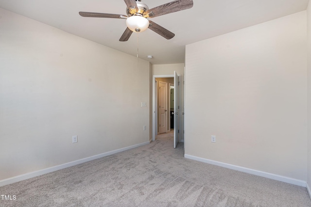 unfurnished room featuring ceiling fan, baseboards, and light colored carpet