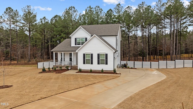 40 Long Needle Ct, Youngsville, NC 27596 - view of front facade with a wooded view, fence, and roof with shingles
