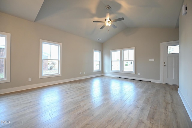 unfurnished living room with vaulted ceiling, ceiling fan, a baseboard heating unit, and light hardwood / wood-style flooring