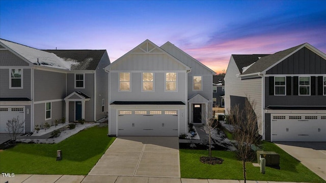 view of front of property featuring board and batten siding, concrete driveway, a yard, and a garage