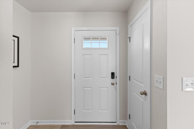 doorway to outside with baseboards