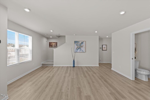 unfurnished living room with light wood-type flooring, stairway, baseboards, and recessed lighting