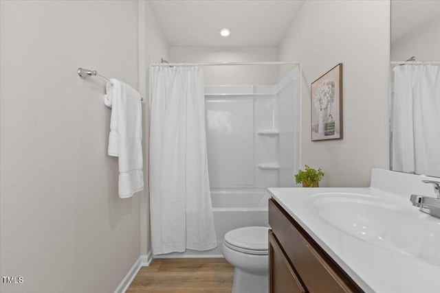 full bathroom with shower / tub combo with curtain, vanity, toilet, and wood finished floors