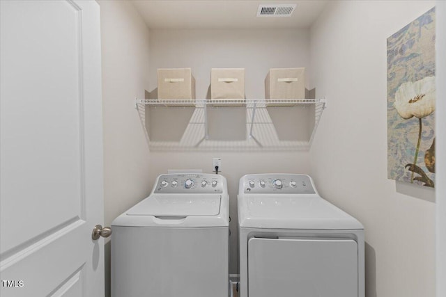 laundry room featuring washing machine and dryer, laundry area, and visible vents