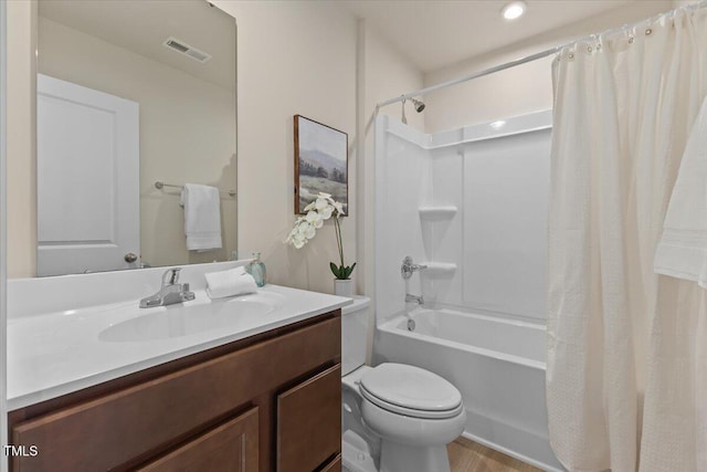 bathroom featuring visible vents, shower / bath combo, vanity, and toilet