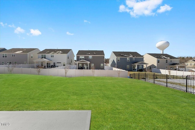 view of yard featuring a fenced backyard and a residential view