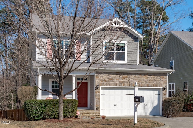 view of front of home featuring driveway and stone siding