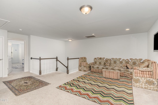 interior space with carpet, recessed lighting, visible vents, attic access, and an upstairs landing