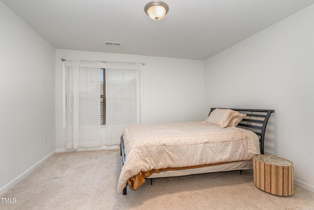 bedroom featuring baseboards, visible vents, and light colored carpet