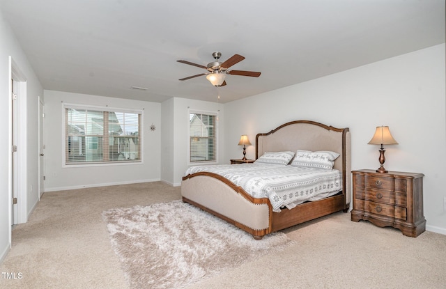 carpeted bedroom with ceiling fan, visible vents, and baseboards