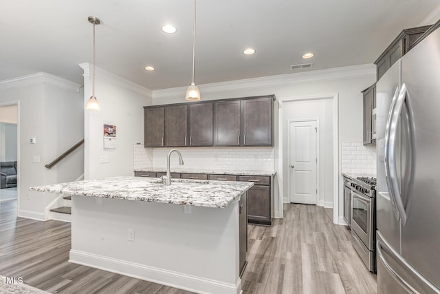 kitchen with stainless steel appliances, crown molding, a sink, and dark brown cabinetry