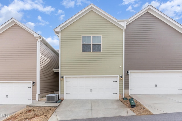 view of front of home with central AC and concrete driveway