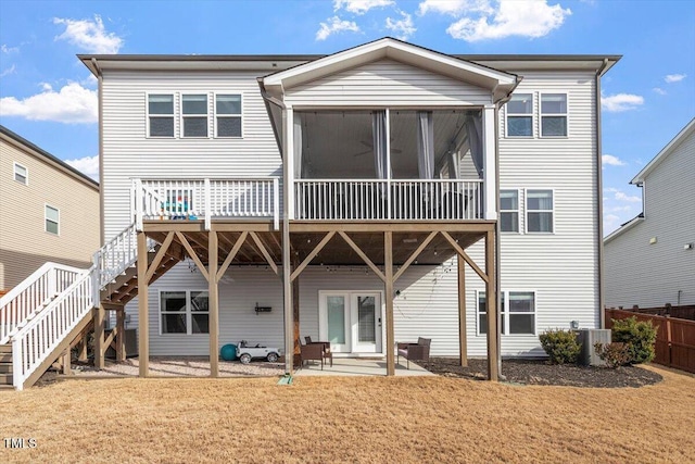 back of property featuring cooling unit, fence, a sunroom, stairs, and a patio area