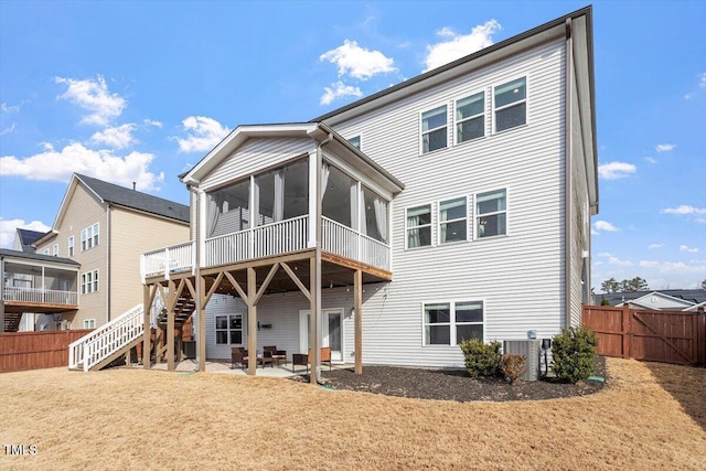 back of house featuring a patio, stairway, central AC unit, a sunroom, and fence