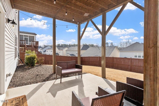 view of patio / terrace featuring outdoor lounge area, a fenced backyard, and a residential view