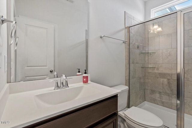 full bathroom featuring toilet, a stall shower, visible vents, and vanity