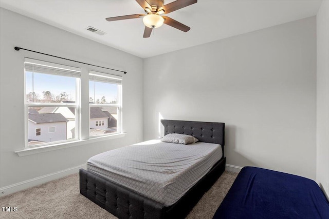 bedroom with a ceiling fan, carpet flooring, visible vents, and baseboards