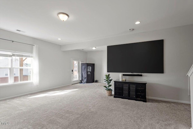 carpeted living room with visible vents, baseboards, and recessed lighting