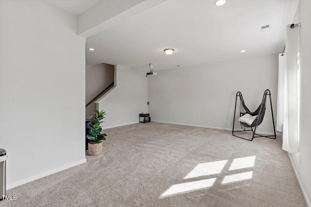 carpeted empty room with baseboards, visible vents, and recessed lighting