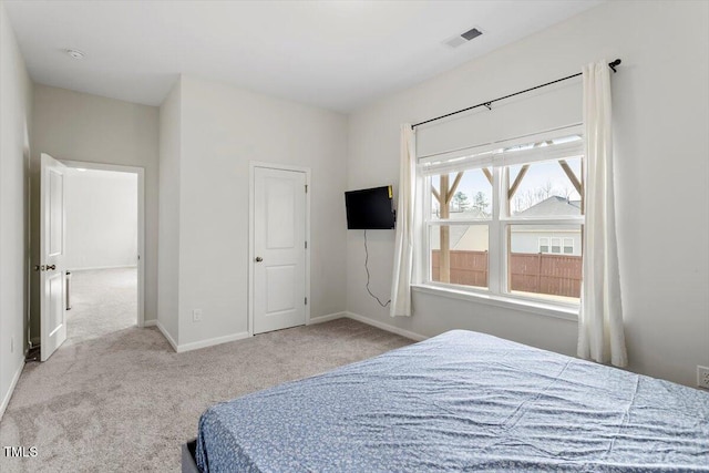 bedroom with carpet, visible vents, and baseboards