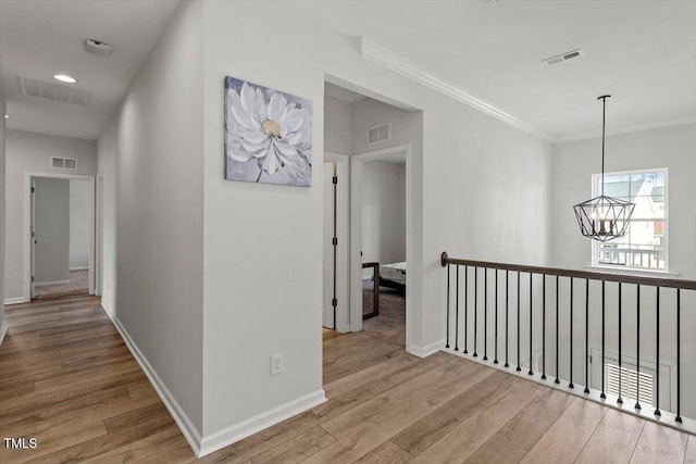 hall featuring wood finished floors and visible vents