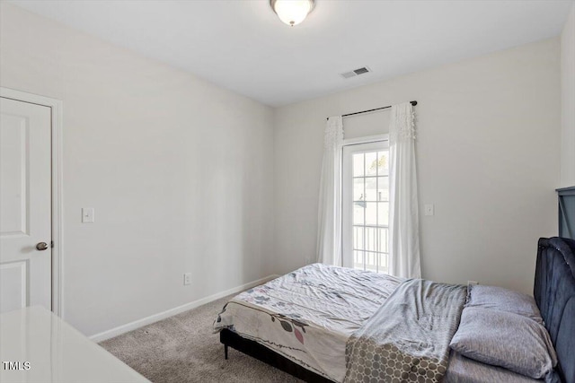 carpeted bedroom featuring visible vents and baseboards