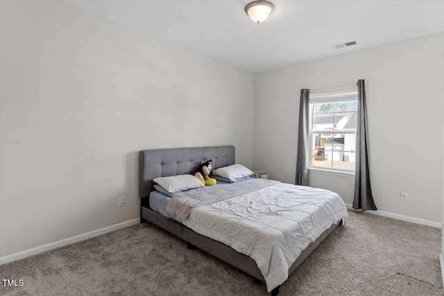 bedroom with baseboards, visible vents, and carpet flooring